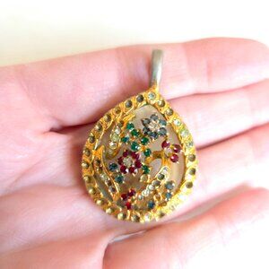 Vintage/antique (?) pendant with green red and clear rhinestones floral design.